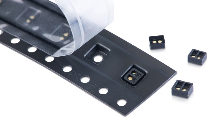 Reel-to-reel overmolded time-of-flight sensor lens made from EXTEM resin.